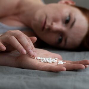 Close Up Depressed Woman Holding Pills